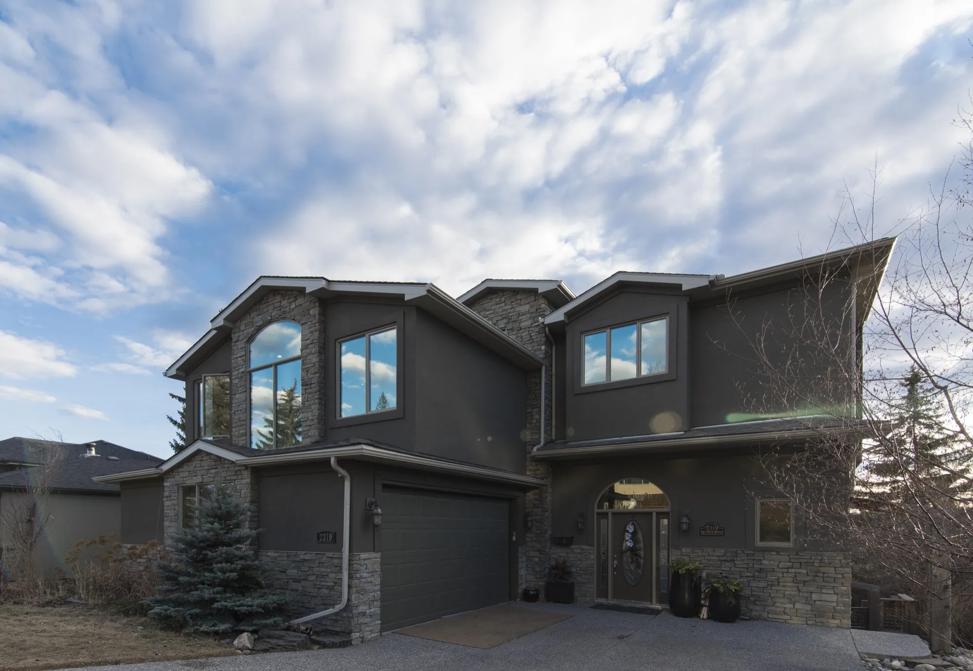 Large newer two-storey home with stone detailing and an attached garage, typical of the Macomb Township, Michigan subdivisions DITA Pro Clean serves