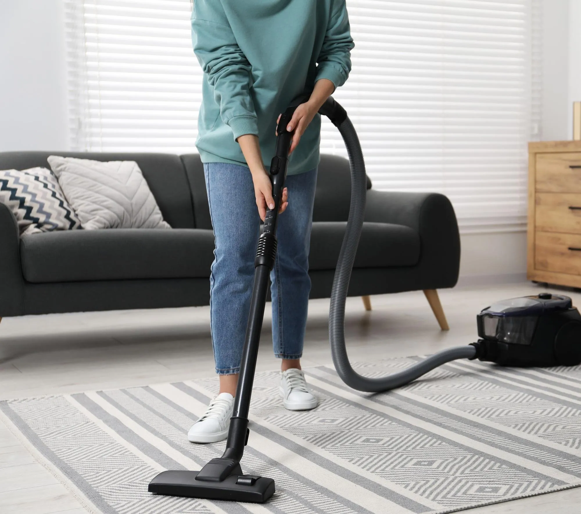DITA Pro Clean cleaner vacuuming a living room carpet on a regular biweekly visit in Sterling Heights